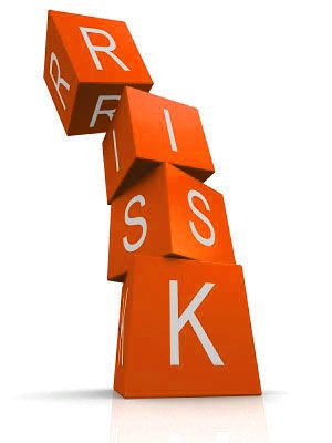 Fyra orangea klossar staplade i en instabil formation som bildar ordet RISK.
